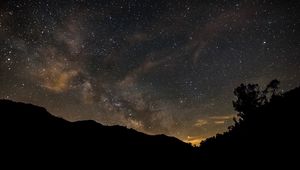 Preview wallpaper milky way, stars, night, hills, silhouettes, space