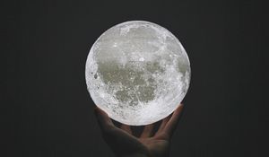 Preview wallpaper moon, ball, hand, sphere, glow