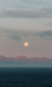 Preview wallpaper moon, mountains, fog, sea, evening
