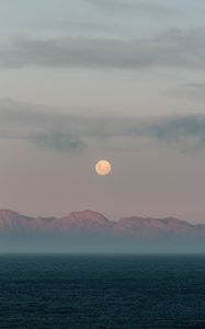 Preview wallpaper moon, mountains, fog, sea, evening