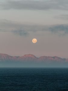 Preview wallpaper moon, mountains, fog, sea, evening