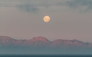 Preview wallpaper moon, mountains, fog, sea, evening