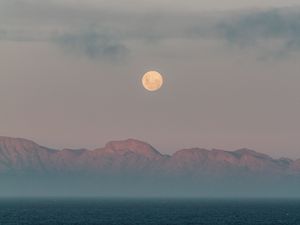 Preview wallpaper moon, mountains, fog, sea, evening