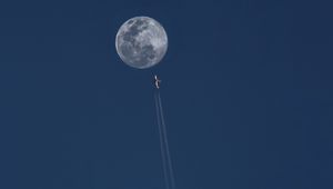 Preview wallpaper moon, plane, trail, sky
