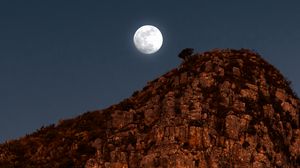 Preview wallpaper moon, rocks, mountains, night, full moon
