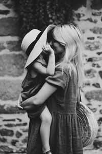 Preview wallpaper mother, child, bw, family, hug, tenderness, hat