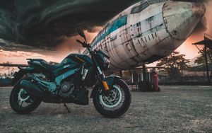 Preview wallpaper motorcycle, airplane, side view, clouds, overcast