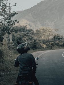 Preview wallpaper motorcycle, black, motorcyclist, helmet, road