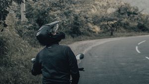 Preview wallpaper motorcycle, black, motorcyclist, helmet, road