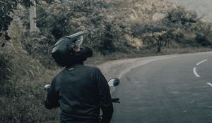 Preview wallpaper motorcycle, black, motorcyclist, helmet, road