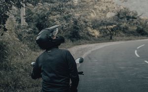Preview wallpaper motorcycle, black, motorcyclist, helmet, road