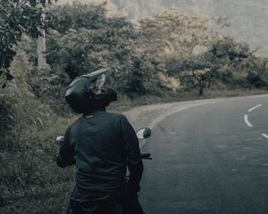 Preview wallpaper motorcycle, black, motorcyclist, helmet, road
