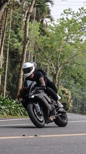 Preview wallpaper motorcycle, black, motorcyclist, speed, road, trees