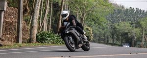 Preview wallpaper motorcycle, black, motorcyclist, speed, road, trees