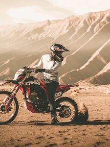 Preview wallpaper motorcycle, cross, motorcyclist, mountains, off-road, sand, helmet