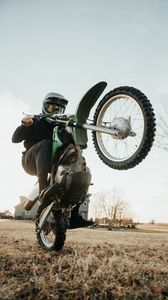 Preview wallpaper motorcycle, green, motorcyclist, trick, wheel