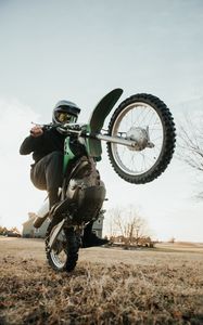 Preview wallpaper motorcycle, green, motorcyclist, trick, wheel