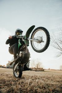 Preview wallpaper motorcycle, green, motorcyclist, trick, wheel