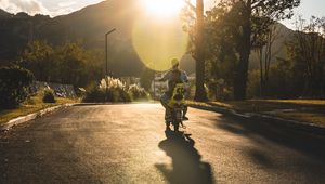 Preview wallpaper motorcycle, motorcyclist, child, road, sunset