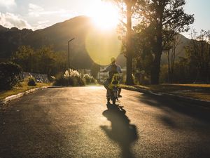 Preview wallpaper motorcycle, motorcyclist, child, road, sunset