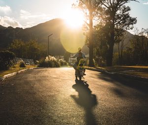 Preview wallpaper motorcycle, motorcyclist, child, road, sunset