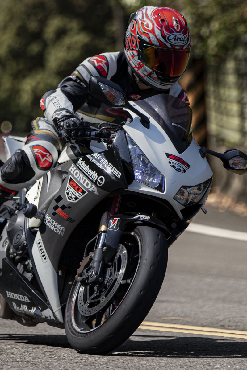 800x1200 Wallpaper motorcycle, motorcyclist, helmet, motorcycle racing