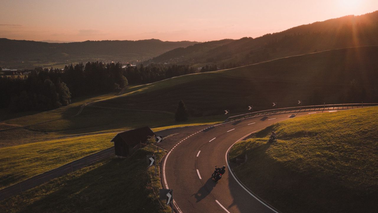 Wallpaper motorcycle, motorcyclist, road, hill, rays