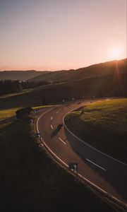 Preview wallpaper motorcycle, motorcyclist, road, hill, rays