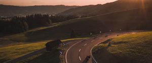 Preview wallpaper motorcycle, motorcyclist, road, hill, rays