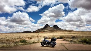 Preview wallpaper motorcycle, mountains, desert, clouds, travel