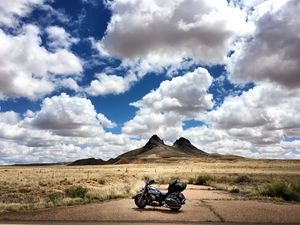 Preview wallpaper motorcycle, mountains, desert, clouds, travel