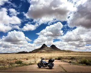 Preview wallpaper motorcycle, mountains, desert, clouds, travel