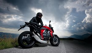 Preview wallpaper motorcycle, racer, road, sky, clouds