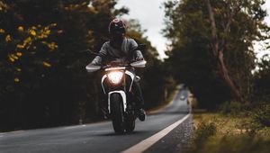 Preview wallpaper motorcycle, white, motorcyclist, road, trees