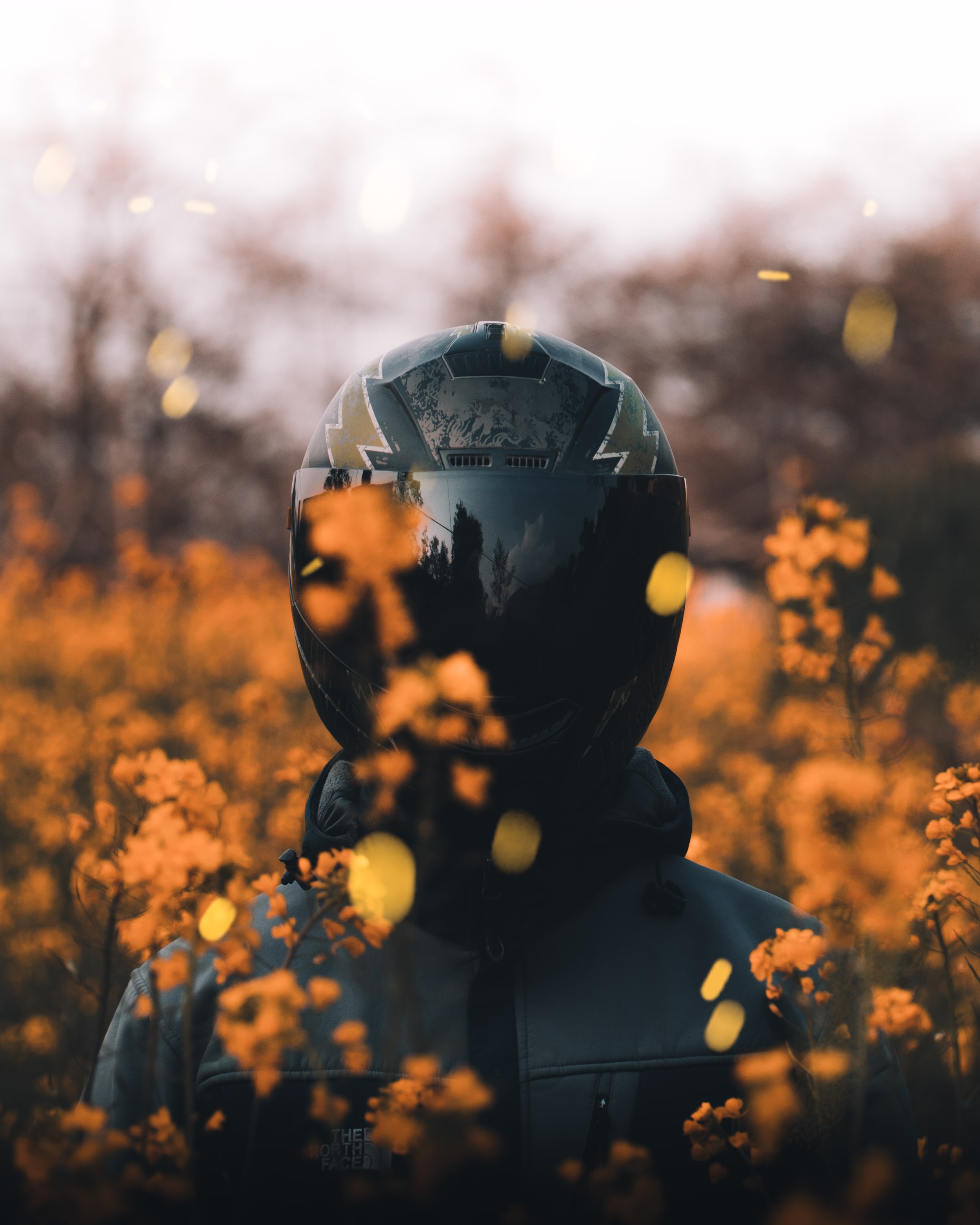 Download wallpaper 2400x3000 motorcyclist, helmet equipment, flowers