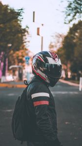 Preview wallpaper motorcyclist, helmet, jacket, backpack, blur