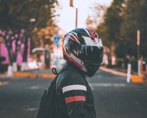 Preview wallpaper motorcyclist, helmet, jacket, backpack, blur