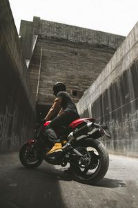 Preview wallpaper motorcyclist, motorcycle, helmet, wall, concrete