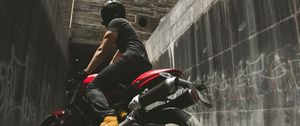 Preview wallpaper motorcyclist, motorcycle, helmet, wall, concrete