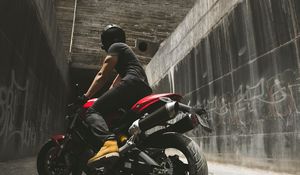 Preview wallpaper motorcyclist, motorcycle, helmet, wall, concrete