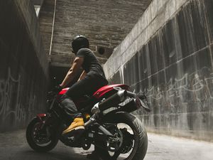 Preview wallpaper motorcyclist, motorcycle, helmet, wall, concrete