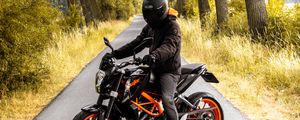 Preview wallpaper motorcyclist, motorcycle, helmet, road