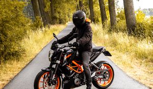 Preview wallpaper motorcyclist, motorcycle, helmet, road