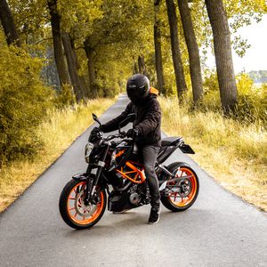 Preview wallpaper motorcyclist, motorcycle, helmet, road