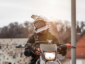 Preview wallpaper motorcyclist, motorcycle, helmet, sunlight