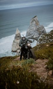 Preview wallpaper motorcyclist, motorcycle, helmet, rocks