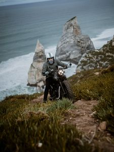 Preview wallpaper motorcyclist, motorcycle, helmet, rocks