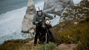 Preview wallpaper motorcyclist, motorcycle, helmet, rocks