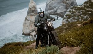 Preview wallpaper motorcyclist, motorcycle, helmet, rocks