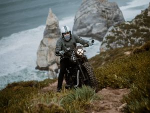 Preview wallpaper motorcyclist, motorcycle, helmet, rocks